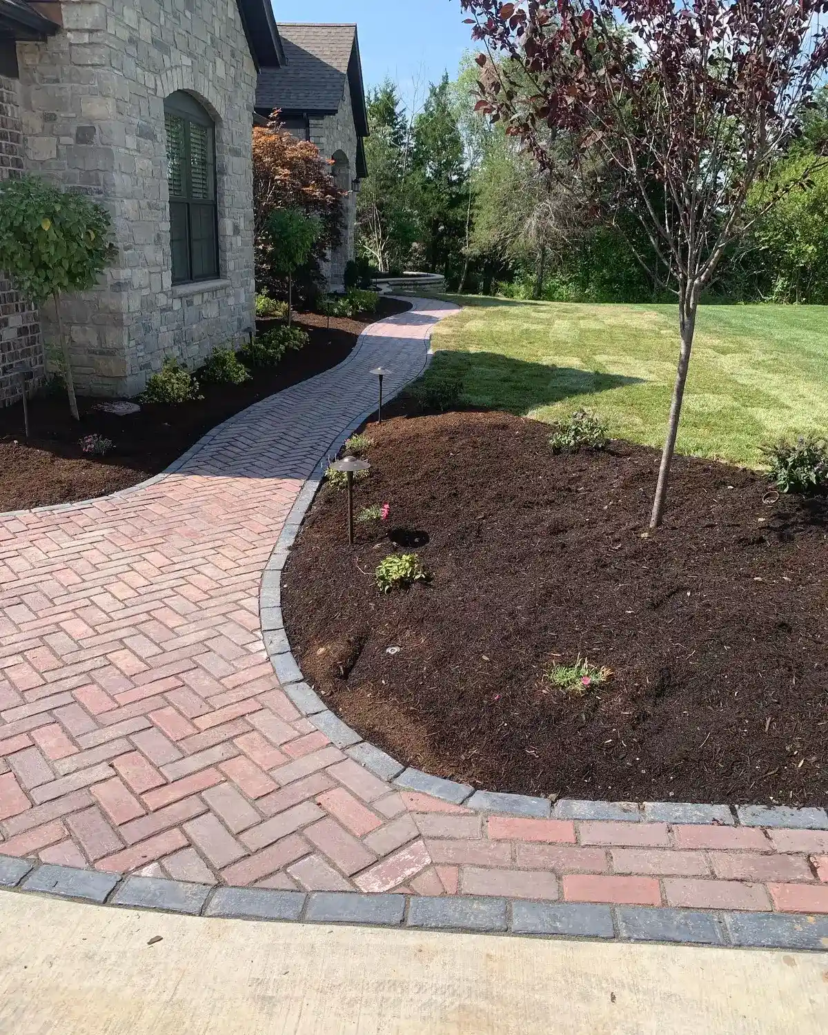Brick herringbone pattern driveway installed by Green Operations