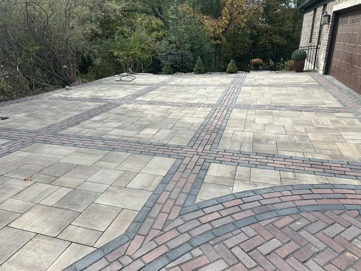 Custom paver driveway with brick accent bands built by Green Operations in St. Charles County, MO