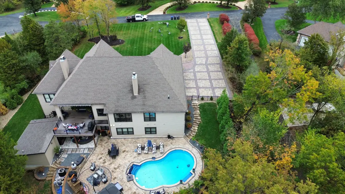 Drone view of paver driveway and backyard pool area in St. Louis