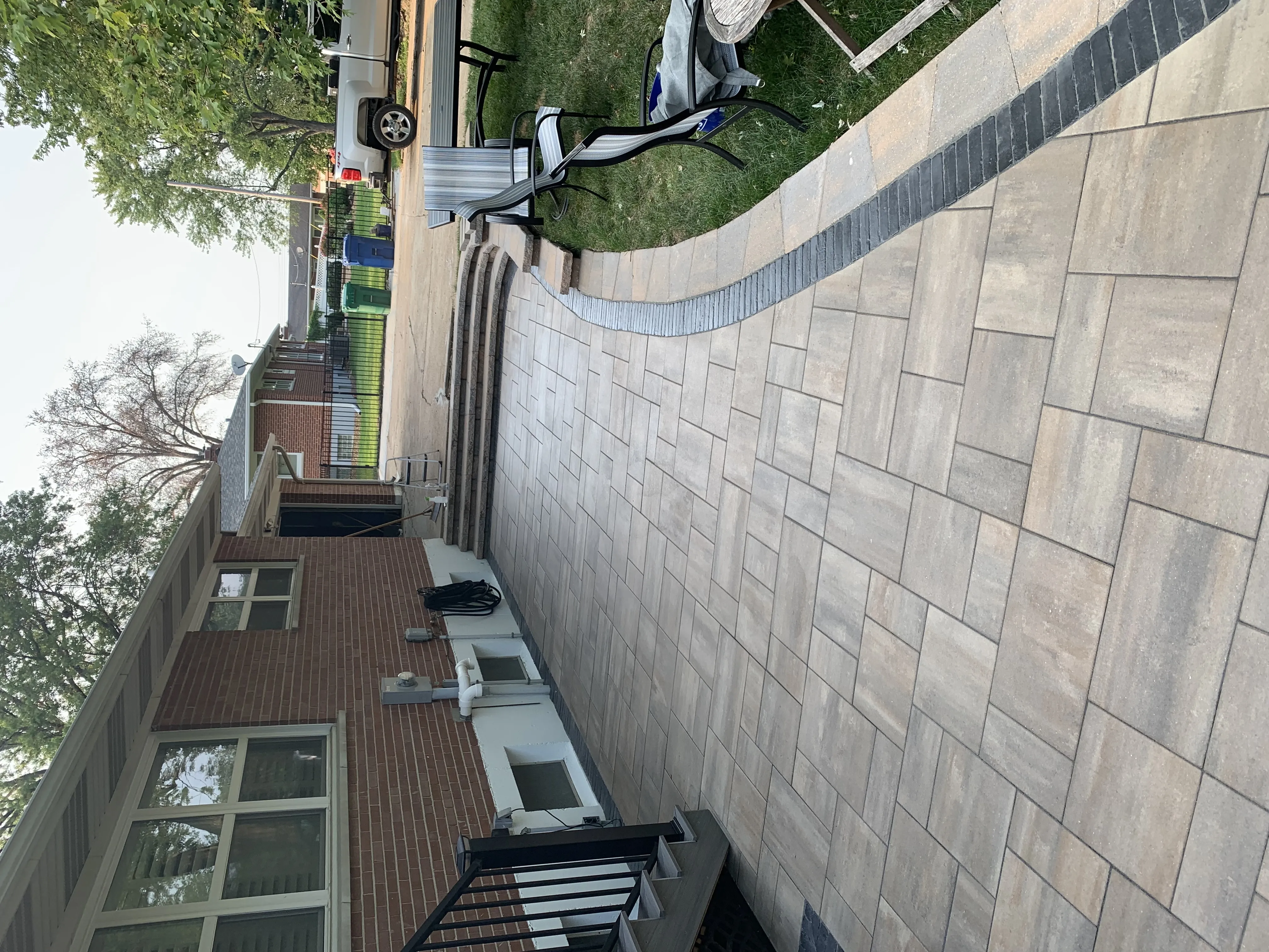 Green Operations branded truck on site during a large-format paver patio installation