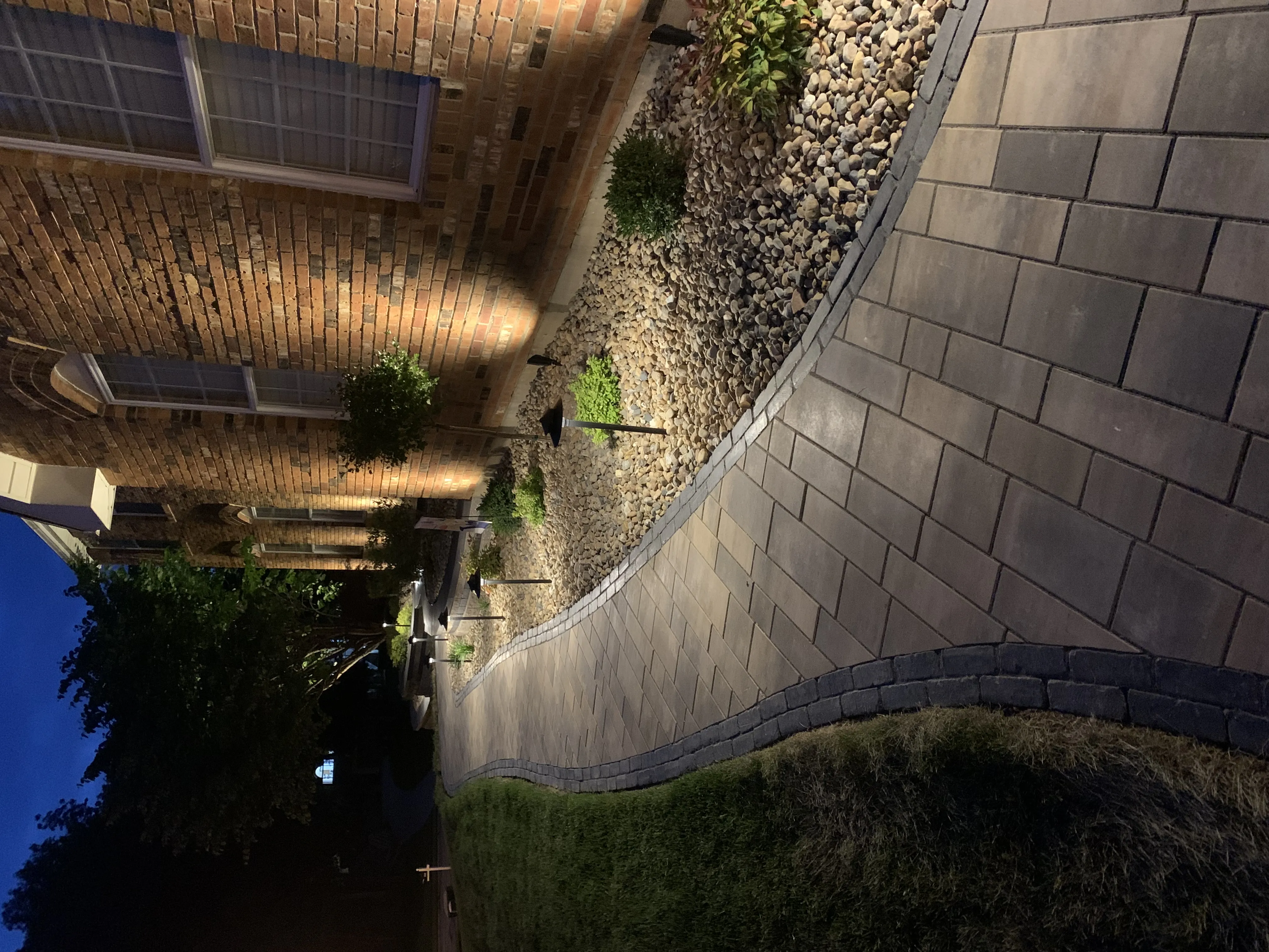Paver walkway with landscape path lights and uplighting at dusk in St. Louis