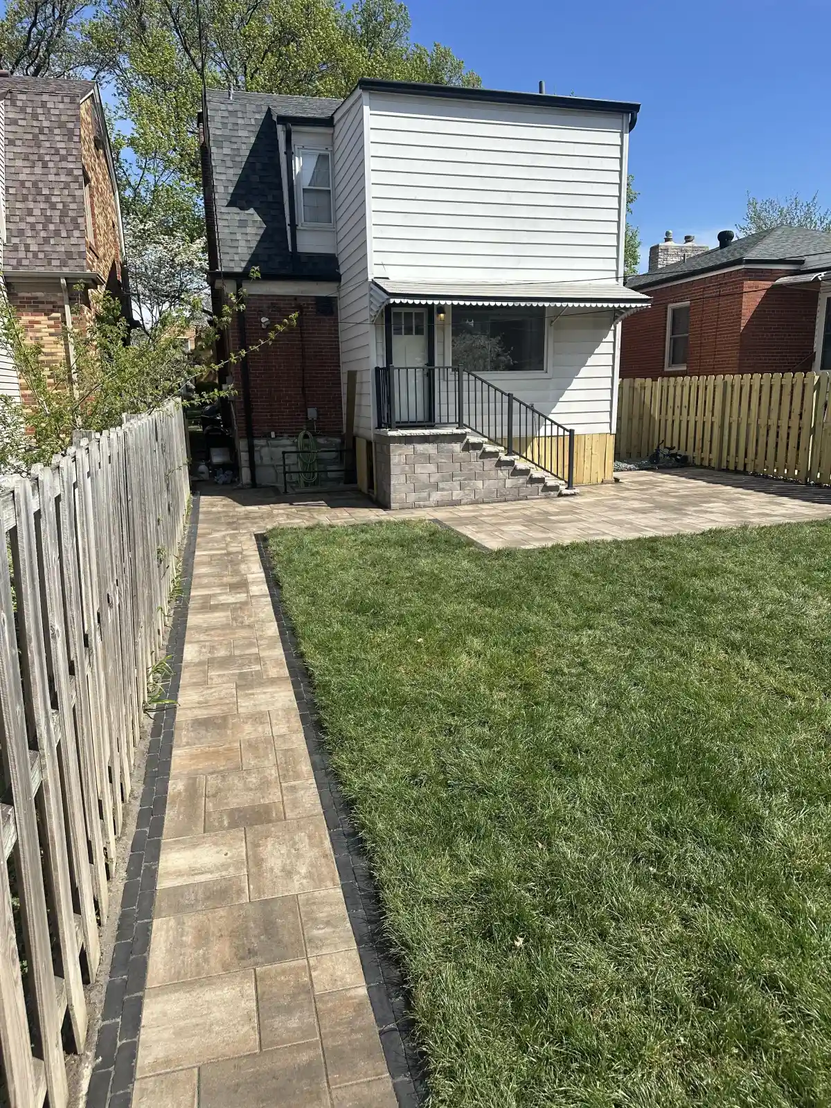 Retaining wall with paver patio and steps in St. Louis backyard