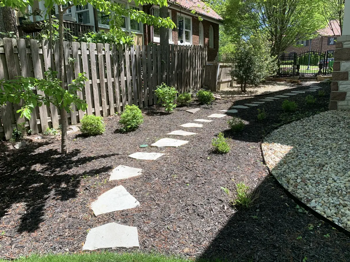 Flagstone stepping path through mulched landscape bed