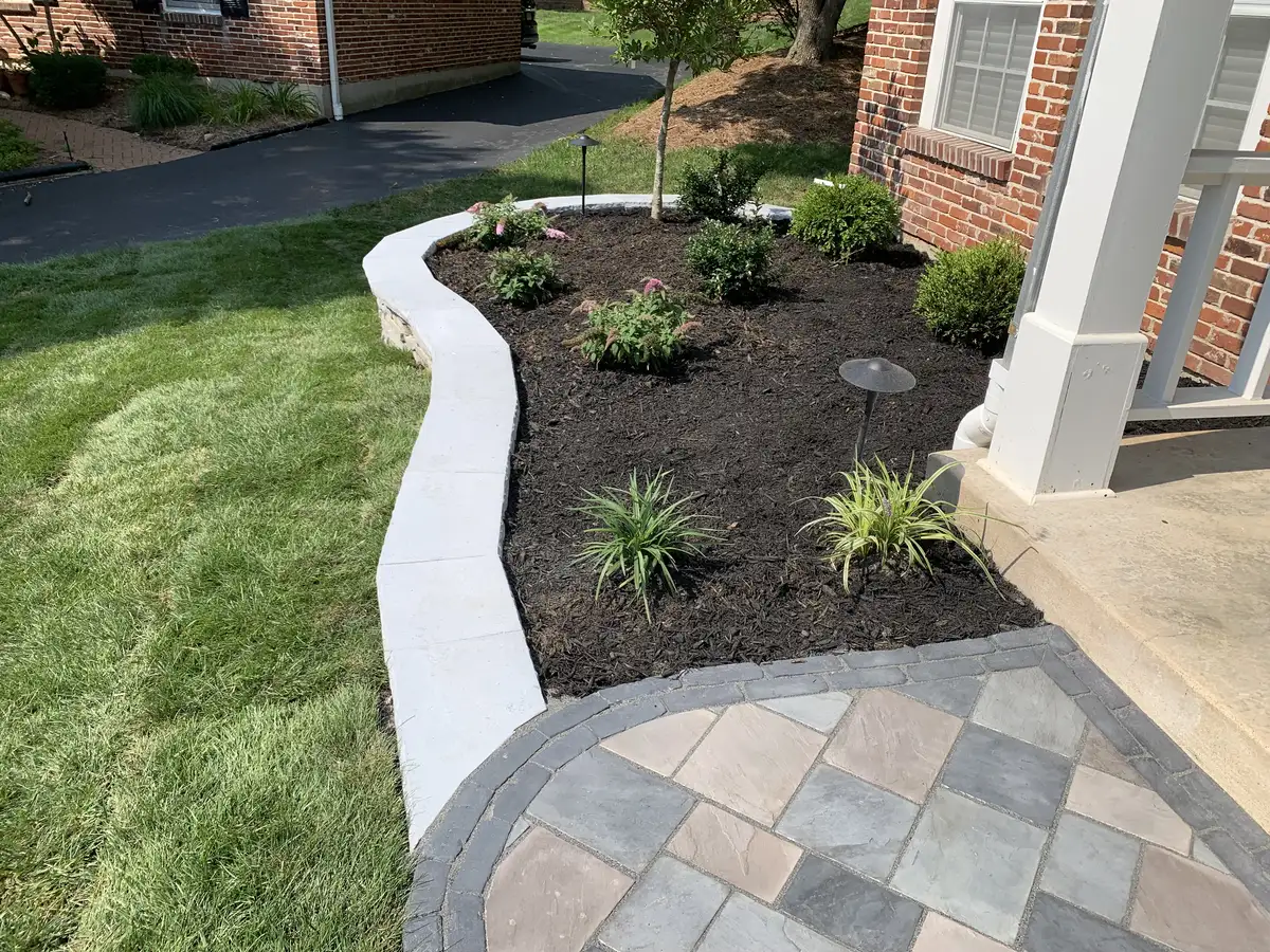 Front yard landscape design with mulch beds, shrubs, and landscape lighting
