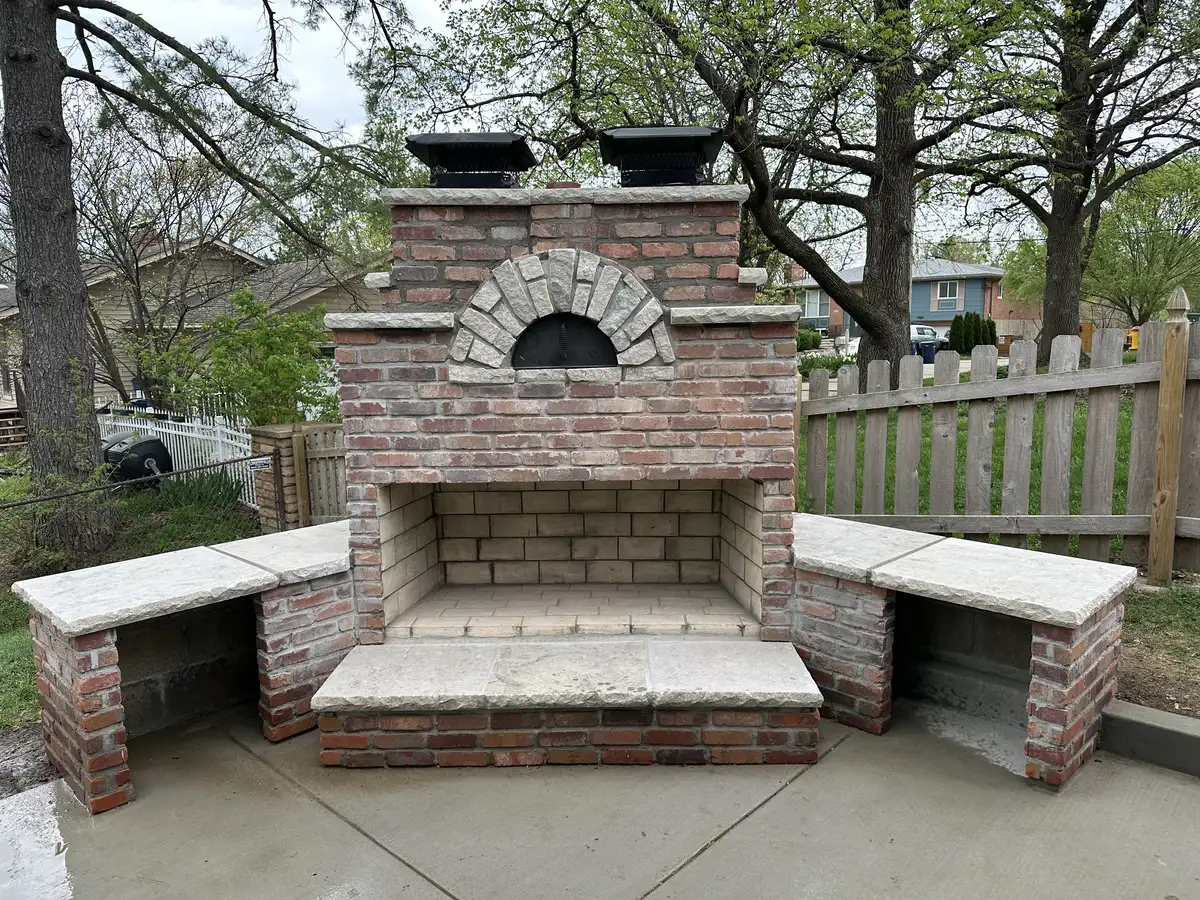 Outdoor brick fireplace and pizza oven built by Green Operations in St. Louis