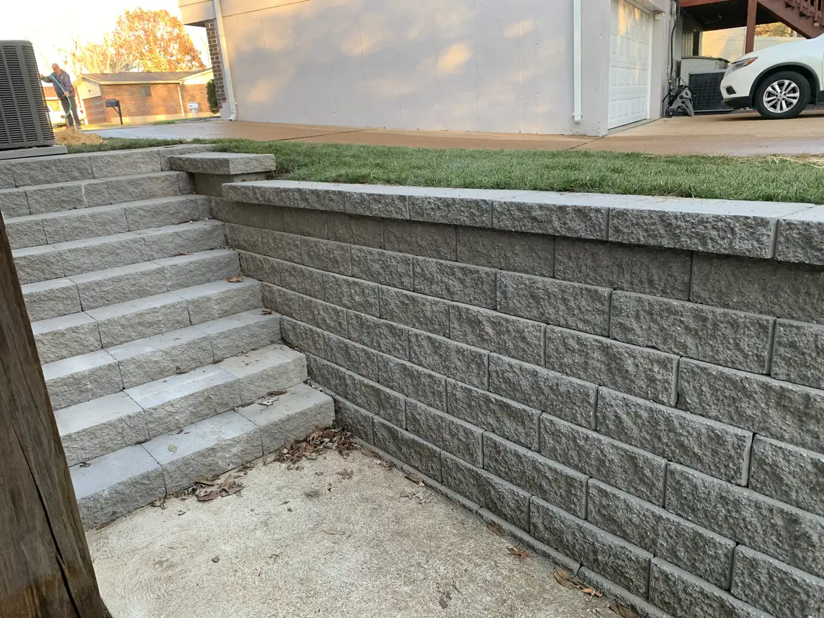Retaining wall with stairs managing a grade change