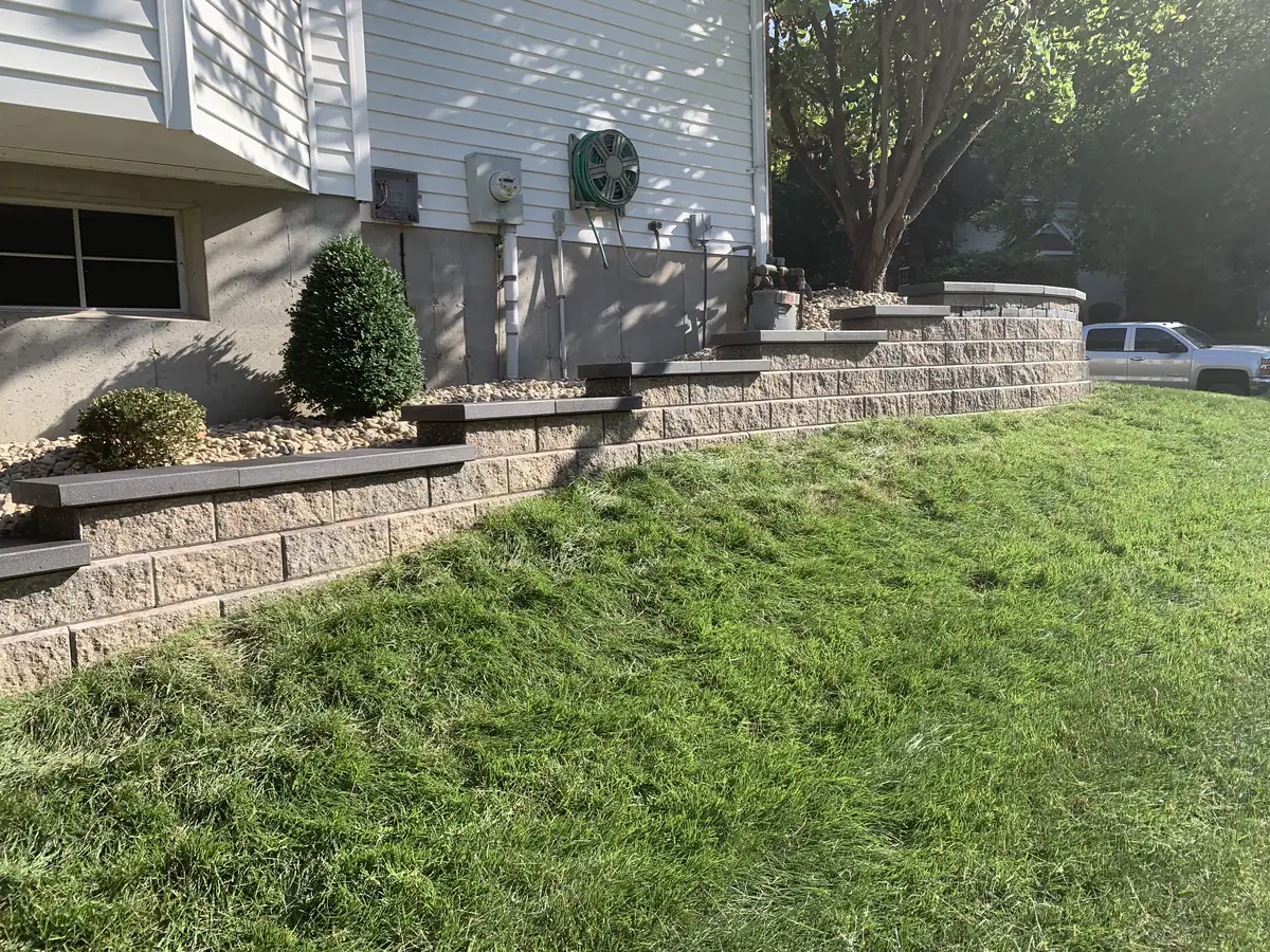 Tiered block retaining wall with integrated steps built by Green Operations in St. Louis