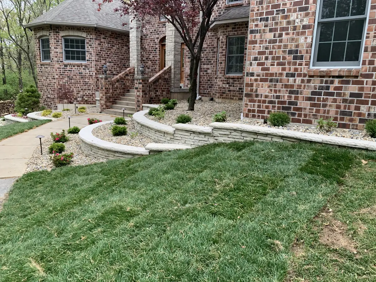 Tiered stone retaining wall with landscaping in St. Louis front yard