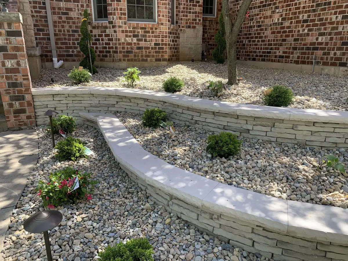 Tiered retaining wall with rock and shrub plantings